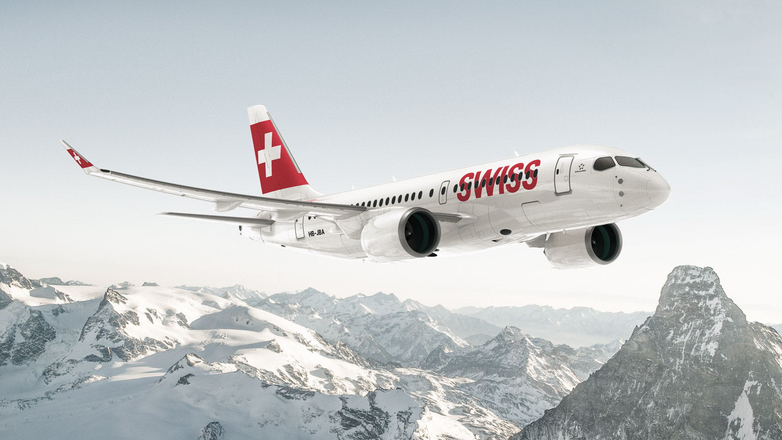 Eine Bombardier CS100 der SWISS über schneebedeckten Bergen